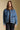 Front  view of a woman wearing the Saltwater Luxe Garder Jacket on a neutral background with hands at sides and black pants