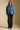 A full body front view of a woman wearing the Saltwater Luxe Garder Jacket on a neutral background