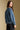 Back view of a woman wearing the Saltwater Luxe Garder Jacket on a neutral background with pants