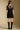 Back view of a woman wearing the Saltwater Luxe Ginna Mini Dress on a neutral background