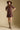 Front view of a woman wearing the Saltwater Luxe Ginna Mini Dress on a neutral background with hat