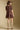 Back view of a woman wearing the Saltwater Luxe Ginna Mini Dress on a neutral background