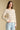 Front view of a woman wearing the Saltwater Luxe Hadlee Sweater on a neutral background with hand on hip