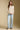 A full body front view of a woman wearing the Saltwater Luxe Hadlee Sweater on a neutral background