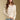 Front view of a woman wearing the Saltwater Luxe Hadlee Sweater on a neutral background with hands clasped