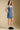 Front view of a woman wearing the Saltwater Luxe Haydin MinI Dress on a neutral background with hand in pocket