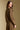 Back view of a woman wearing the Saltwater Luxe Idella Pullover on a neutral background with pants