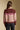 Back view of a woman wearing the Saltwater Luxe Isabeau Sweater on a neutral background with arms at sides