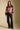 A full body front view of a woman wearing the Saltwater Luxe Isabeau Sweater on a neutral background