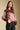 Side angle view of a woman wearing the Saltwater Luxe Isabeau Sweater on a neutral background with hand in pocket