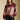 Front view of a woman wearing the Saltwater Luxe Isabeau Sweater on a neutral background with hand in pocket