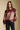 Front view of a woman wearing the Saltwater Luxe Isabeau Sweater on a neutral background with hand in pocket