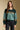 Front view of a woman wearing the Saltwater Luxe Isabeau Sweater on a neutral background with arms lowered