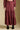 Front view of a woman wearing the Saltwater Luxe Jaycee Midi Skirt on a neutral background with matching top and boots