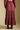 Back view of a woman wearing the Saltwater Luxe Jaycee Midi Skirt on a neutral background with top