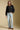 A full body front view of a woman wearing the Saltwater Luxe Jene Jacket on a neutral background