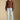 Front  view of a woman wearing the Saltwater Luxe Jeri Sweater on a neutral background with jeans and brown shoes