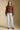 Front  view of a woman wearing the Saltwater Luxe Jeri Sweater on a neutral background with jeans and brown shoes