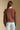 Back view of a woman wearing the Saltwater Luxe Jeri Sweater on a neutral background