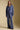 Full body front view of a woman wearing the Saltwater Luxe Joanie Pant on a neutral background with matching top