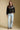 A full body front view of a woman wearing the Saltwater Luxe Joss Sweater on a neutral background