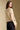 Back view of a woman wearing the Saltwater Luxe Joss Sweater on a neutral background