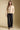 A full body front view of a woman wearing the Saltwater Luxe Joss Sweater on a neutral background