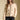Front view of a woman wearing the Saltwater Luxe Joss Sweater on a neutral background with hand in pocket