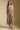 Front view of a woman wearing the Saltwater Luxe Juli Midi Dress on a neutral background with boots
