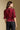 Back view of a woman wearing the Saltwater Luxe Kadie Top on a neutral background with pants