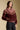 Side angle view of a woman wearing the Saltwater Luxe Kaira Jacket on a neutral background with black jeans