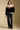 A full body front view of a woman wearing the Saltwater Luxe Kaira Jacket on a neutral background