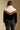Back view of a woman wearing the Saltwater Luxe Kaira Jacket on a neutral background with arms at sides