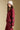 Side angle view of a woman wearing the Saltwater Luxe Kevvy Pullover on a neutral background with crimson pants
