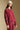 Side angle view of a woman wearing the Saltwater Luxe Kevvy Pullover on a neutral background with red pants