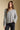 Front view of a woman wearing the Saltwater Luxe Kirra Sweater on a neutral background with hands at sides