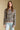 Front view of a woman wearing the Saltwater Luxe Kirra Sweater on a neutral background with hands at sides