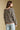 Back view of a woman wearing the Saltwater Luxe Kirra Sweater on a neutral background with jeans