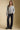A full body front view of a woman wearing the Saltwater Luxe Kirra Sweater on a neutral background