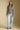 A full body front view of a woman wearing the Saltwater Luxe Kirra Sweater on a neutral background