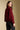 Back view of a woman wearing the Saltwater Luxe Klarke Sweater on a neutral background with pants
