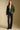A full body front view of a woman wearing the Saltwater Luxe Klarke Sweater on a neutral background