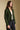 Side angle view of a woman wearing the Saltwater Luxe Klarke Sweater on a neutral background with arms at sides