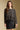 Front view of a woman wearing the Saltwater Luxe Korrie Top on a neutral background with Ralie skirt and arms lowered
