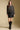 A full body front view of a woman wearing the Saltwater Luxe Korrie Top on a neutral background