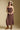 Front view of a woman wearing the Saltwater Luxe Laken Midi Dress on a neutral background with hands clasped