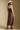 Back view of a woman wearing the Saltwater Luxe Laken Midi Dress on a neutral background