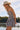 Side view of a woman wearing the Saltwater Luxe Leightyn Mini Dress with cowboy hat in front of a lake