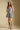 Front view of a woman wearing the Saltwater Luxe Leightyn Mini Dress on a neutral background with cowboy hat