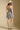 Back view of a woman wearing the Saltwater Luxe Leightyn Mini Dress on a neutral background